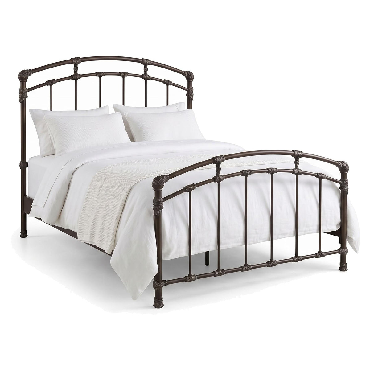 Test Iron Bed by Wesley Allen in Aged Bronze finish in Queen size. A metal bed frame with an arched headboard and footboard, shown with white bedding and pillows on a clean white background.