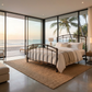 Aristella Iron Bed by Matriae an ocean front modern bedroom with glass doors.