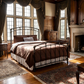 Aristella Iron Bed by Matriae in a historic luxury bedroom with wooden furniture, and large windows.