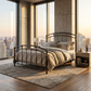 Aristella Iron Bed by Matriae in a high rise bedroom with a city skyline view