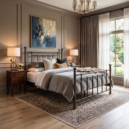 Blake iron bed 1094 in Aged Gold finish, queen size, in a bedroom with a wood nightstand, blue abstract art, and gray bedding, by Wesley Allen for Matriae.