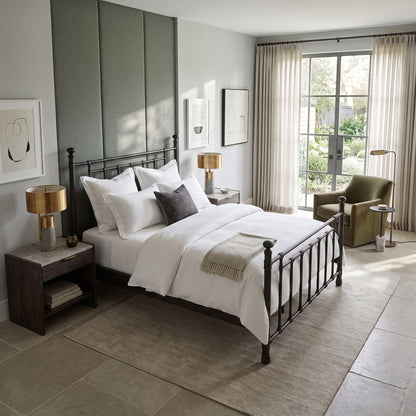 Blake iron bed 1094 in Aged Iron finish, queen size, in a bedroom with a sage upholstered wall panel and white bedding, by Wesley Allen for Matriae.